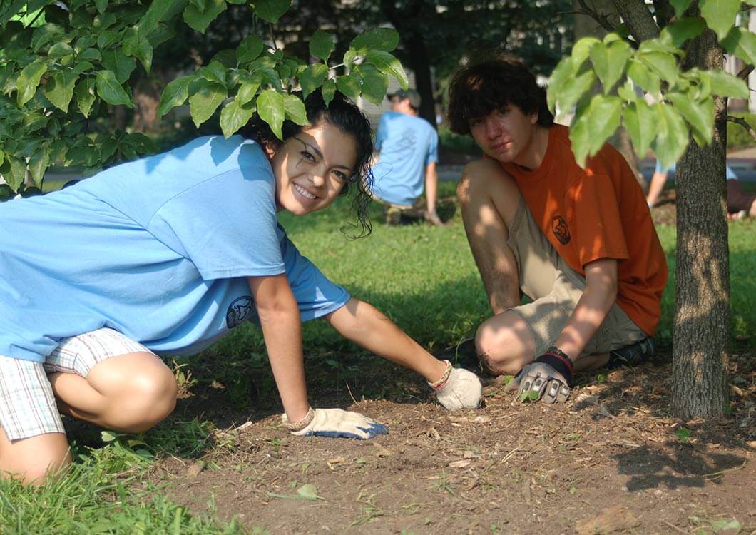 Two teenagers planting